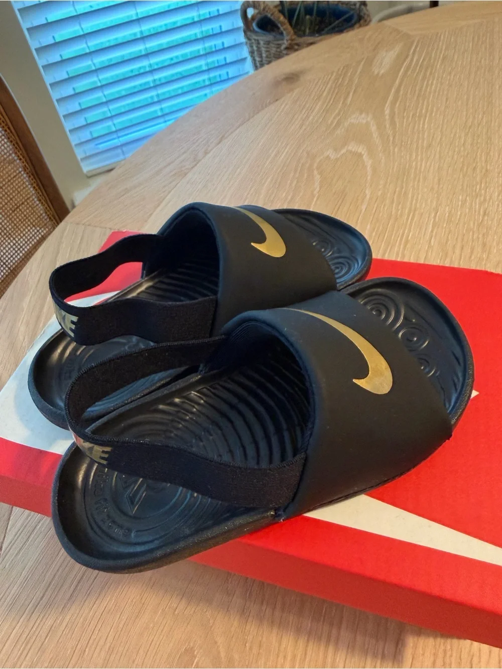 Nike Kids Black Slides with Gold Swoosh and Heel Strap